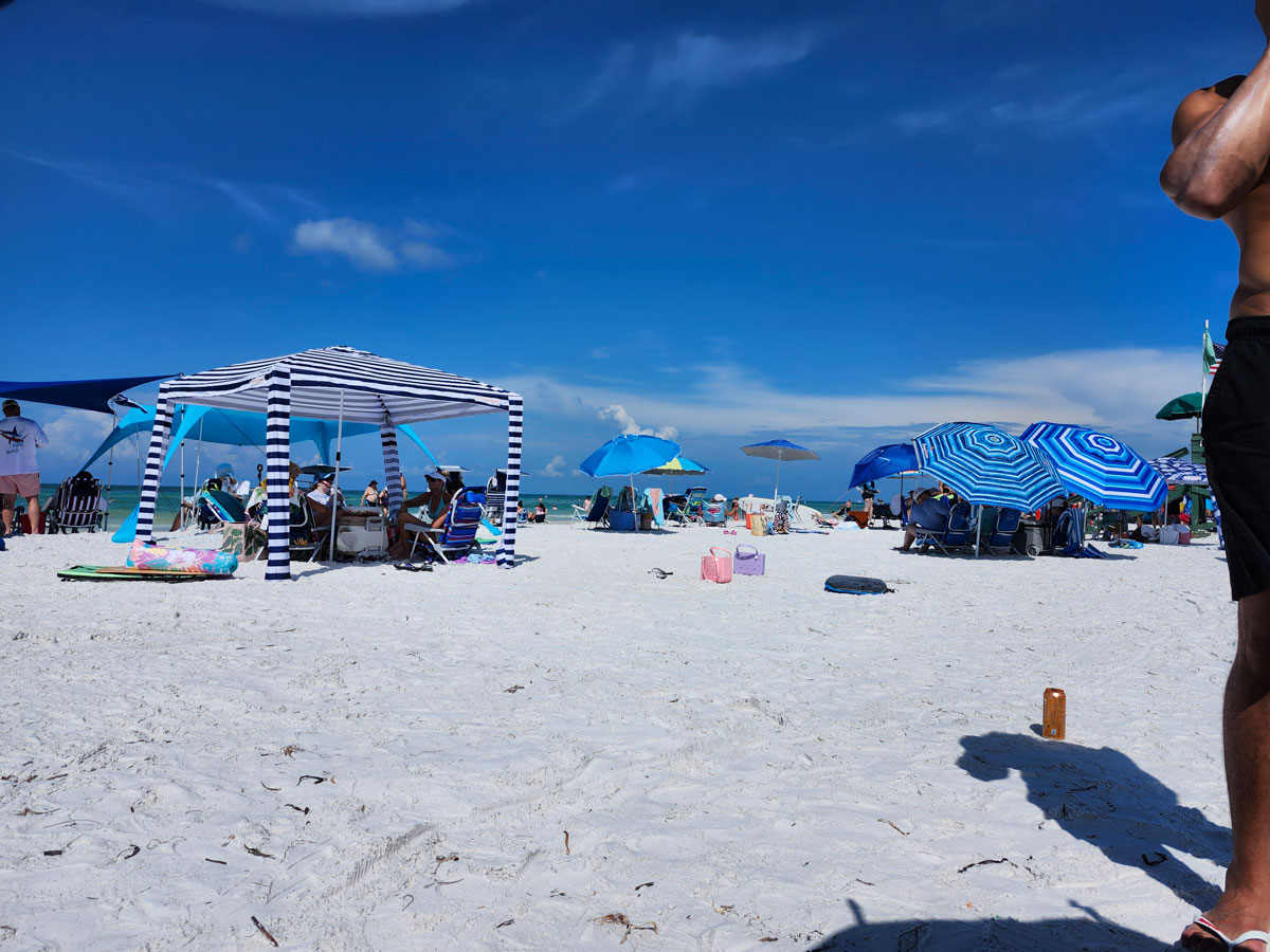 Umbrellas and beach cabanas on the white sand at Siesta Key Beach on a sunny day
